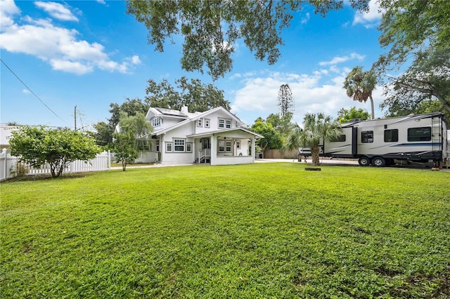 rear view of house with a yard