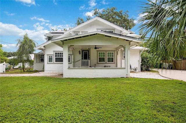 rear view of house with a yard and a porch