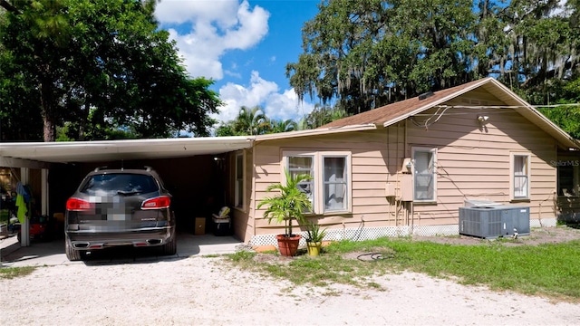 view of front facade with central AC and a carport