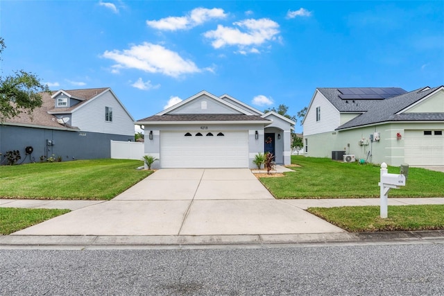 view of front of house featuring cooling unit, a front yard, and a garage