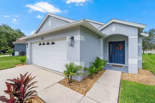 ranch-style home featuring a front lawn and a garage