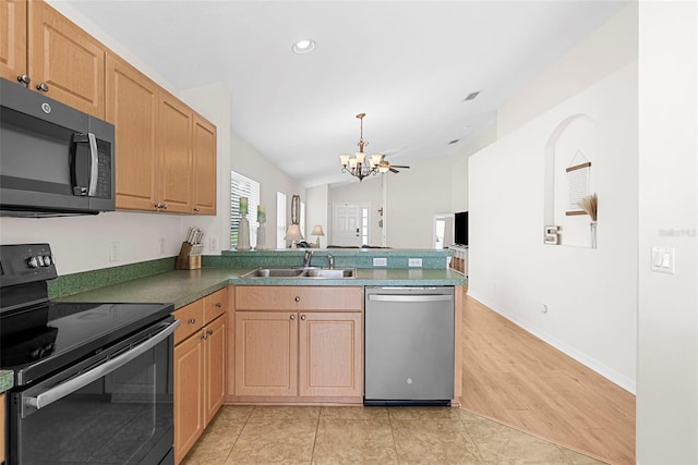 kitchen featuring light hardwood / wood-style floors, sink, a notable chandelier, lofted ceiling, and appliances with stainless steel finishes