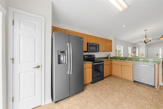 kitchen with appliances with stainless steel finishes, kitchen peninsula, lofted ceiling, an inviting chandelier, and sink