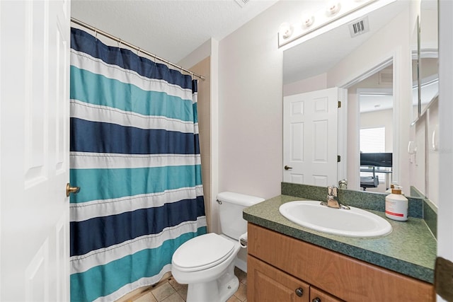 bathroom featuring vanity, a textured ceiling, a shower with shower curtain, toilet, and tile patterned floors