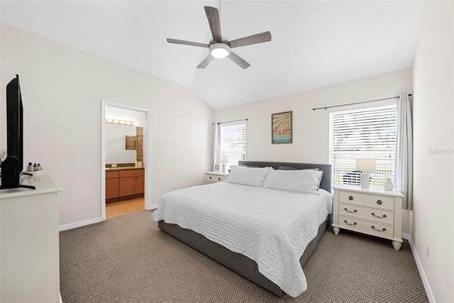 carpeted bedroom featuring ceiling fan, lofted ceiling, connected bathroom, and multiple windows