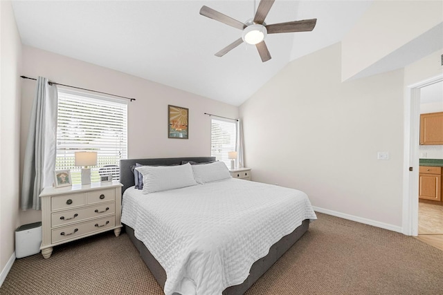 carpeted bedroom with lofted ceiling, ceiling fan, and ensuite bathroom