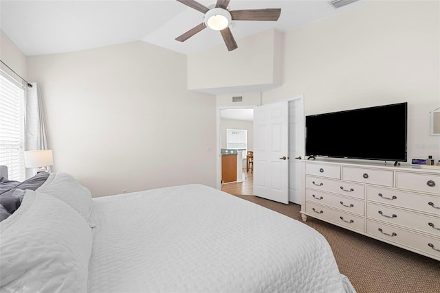 carpeted bedroom featuring vaulted ceiling and ceiling fan