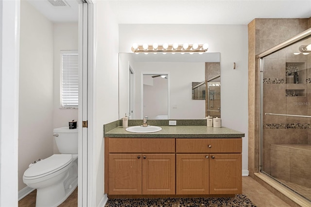 bathroom with vanity, an enclosed shower, and toilet