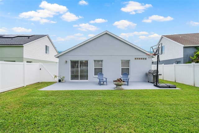 rear view of house with a yard and a patio