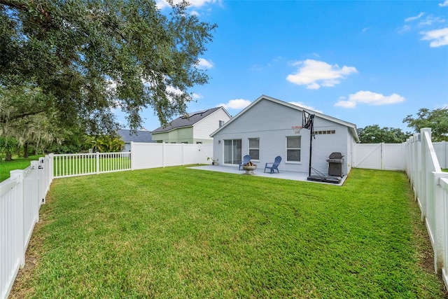 back of house with a yard and a patio area