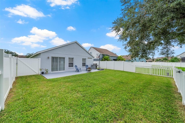 rear view of house featuring a patio area and a yard