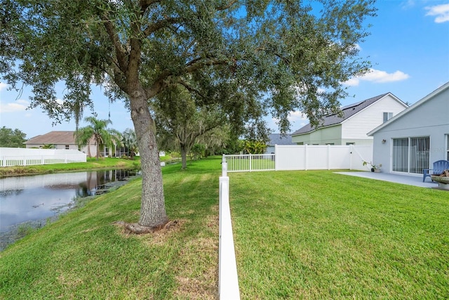 view of yard with a water view and a patio area