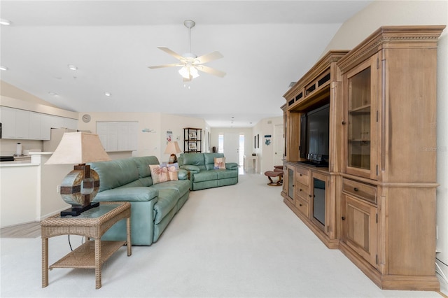 carpeted living room with lofted ceiling and ceiling fan