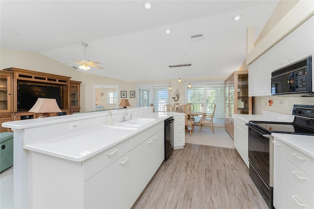 kitchen with ceiling fan, white cabinets, vaulted ceiling, and black appliances