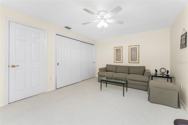 carpeted living room featuring ceiling fan