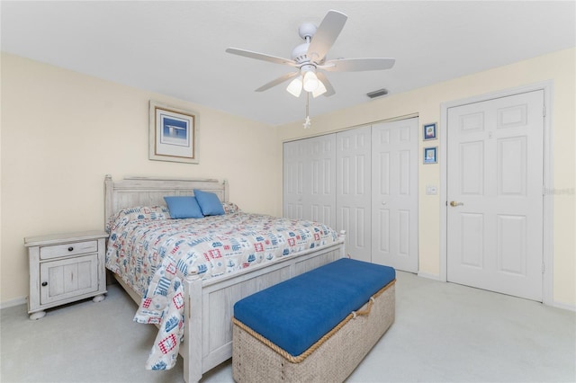 bedroom with ceiling fan and light colored carpet