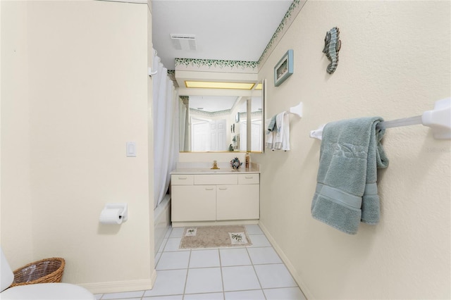 bathroom featuring curtained shower, vanity, toilet, and tile patterned floors