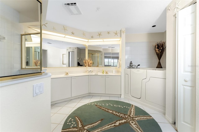 bathroom featuring vanity, a tub, and tile patterned floors