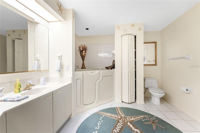 bathroom featuring vanity, tile patterned flooring, and toilet