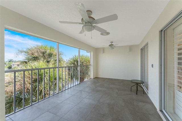 unfurnished sunroom with ceiling fan