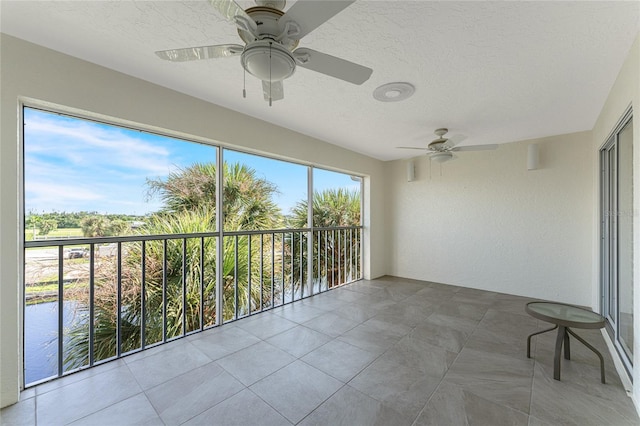 interior space with ceiling fan