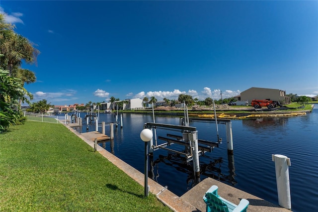 view of dock featuring a water view and a yard