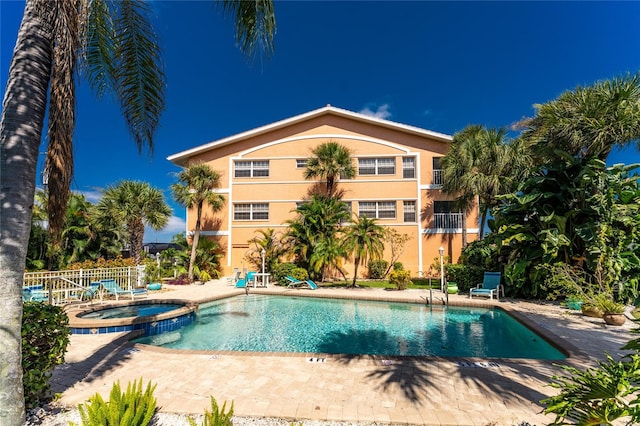 view of pool featuring a patio area and a community hot tub