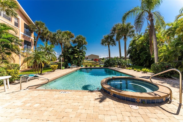 view of pool with a community hot tub