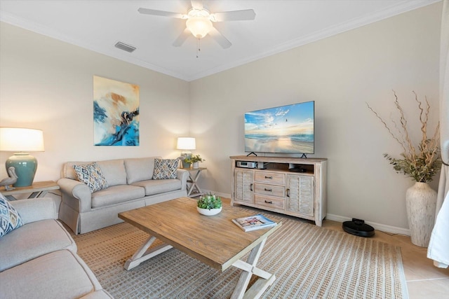 living room featuring light tile patterned floors, ornamental molding, and ceiling fan