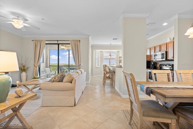 tiled living room with ornamental molding and ceiling fan