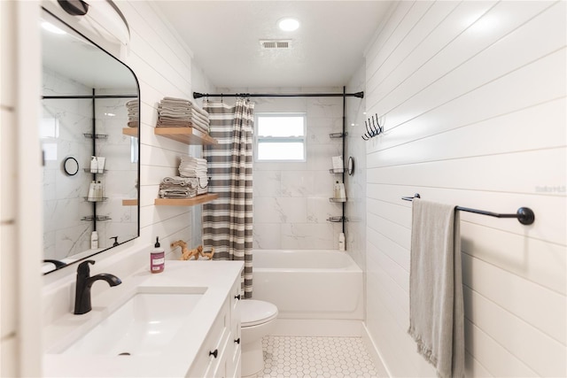 full bathroom featuring shower / tub combo, tile patterned flooring, vanity, and toilet