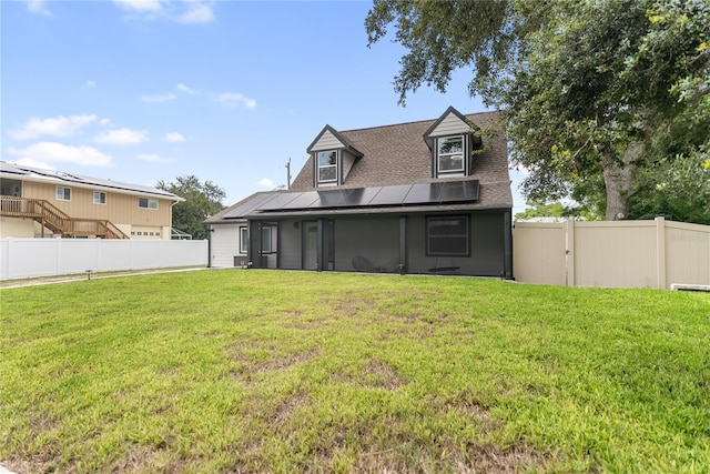 back of house with a lawn