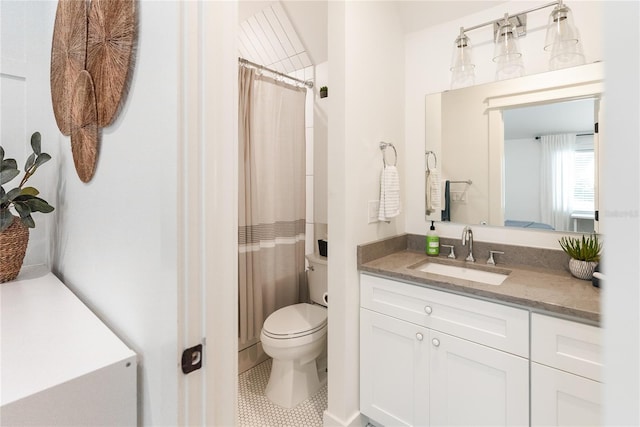 bathroom with curtained shower, vanity, toilet, and tile patterned floors