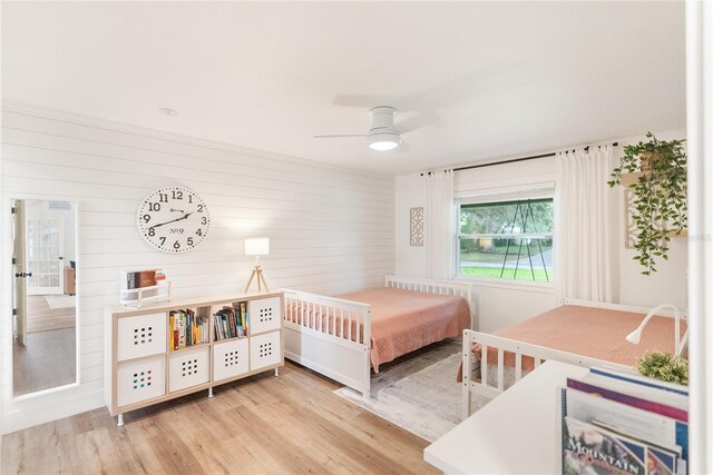 bedroom with ceiling fan and light hardwood / wood-style floors