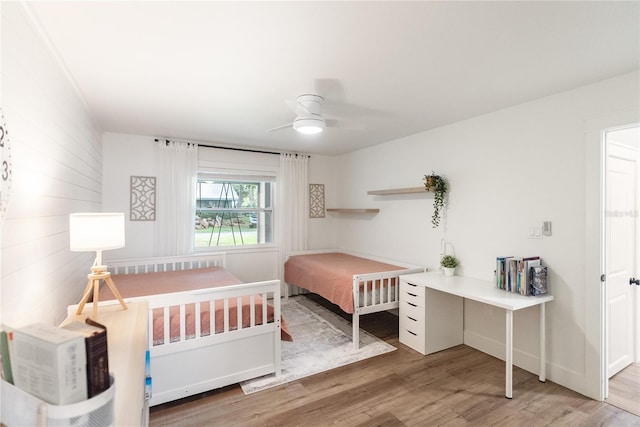 bedroom with ceiling fan and hardwood / wood-style floors