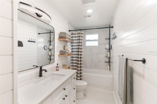 full bathroom featuring shower / tub combo, vanity, and toilet