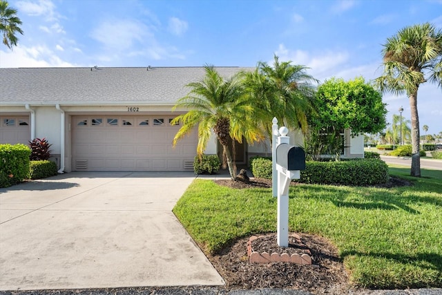 view of front of property featuring a garage and a front yard