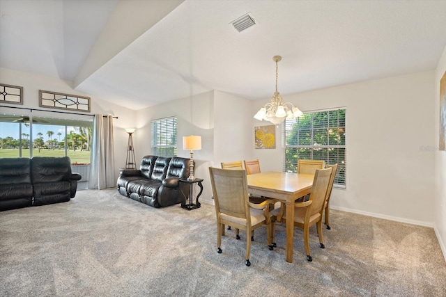 dining area featuring carpet floors, an inviting chandelier, and a healthy amount of sunlight