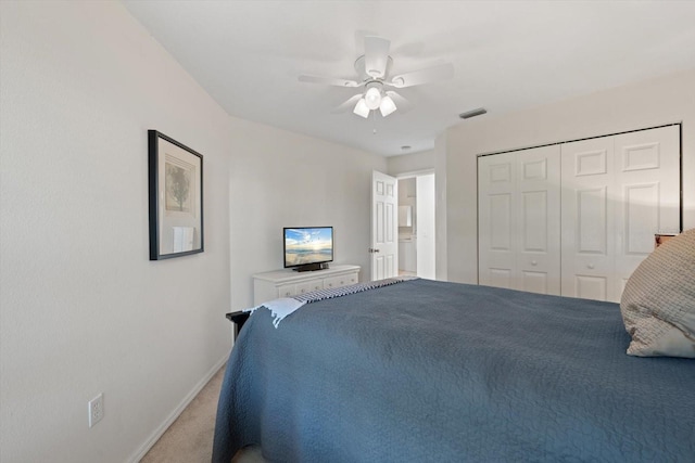 carpeted bedroom with ceiling fan and a closet