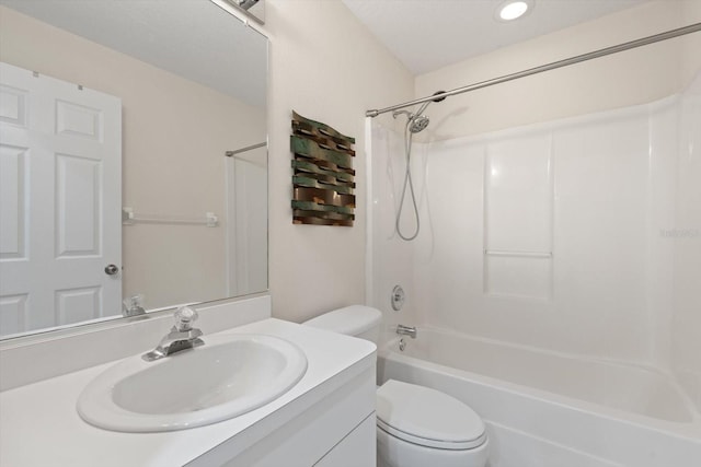 full bathroom featuring bathtub / shower combination, vanity, and toilet