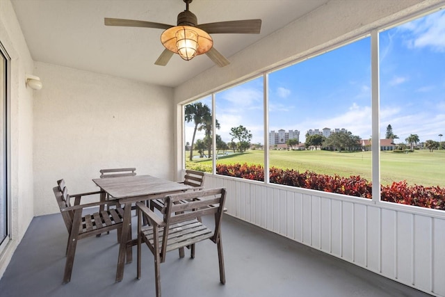 sunroom featuring ceiling fan