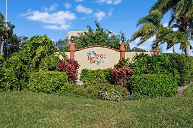 community / neighborhood sign with a lawn