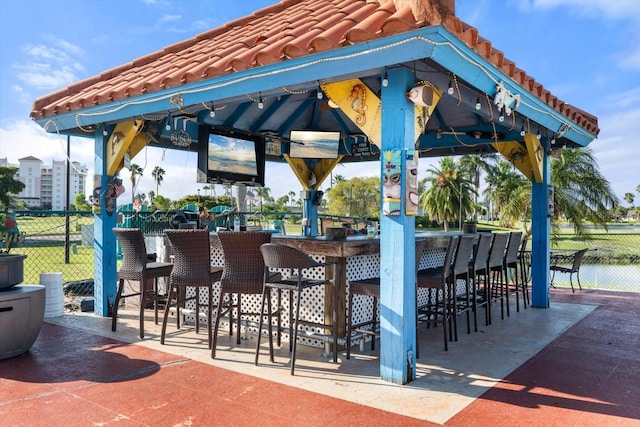 view of patio / terrace featuring a bar and a gazebo