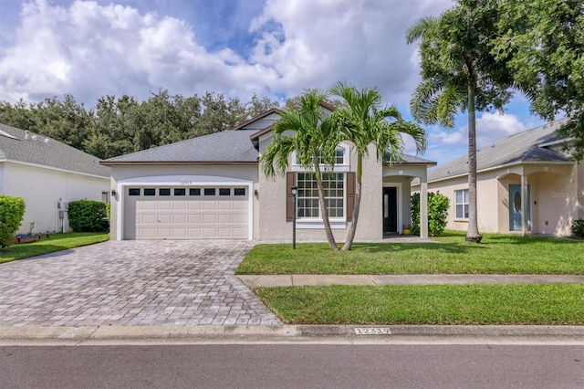 view of front of property with a front lawn and a garage