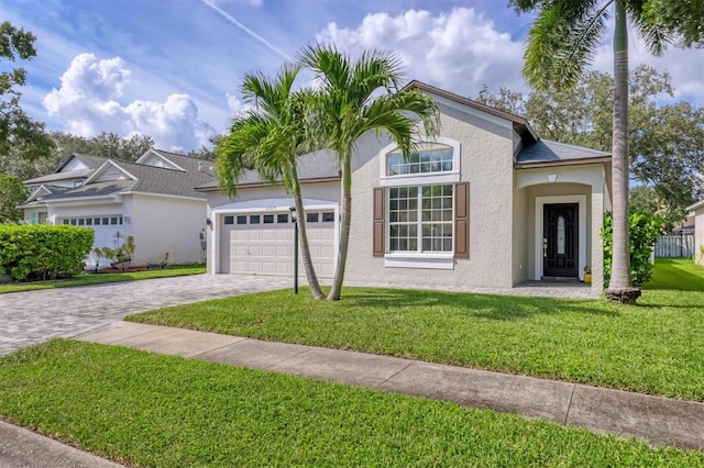 view of front facade with a front yard and a garage