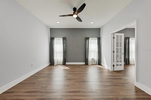 spare room featuring ceiling fan and dark hardwood / wood-style floors