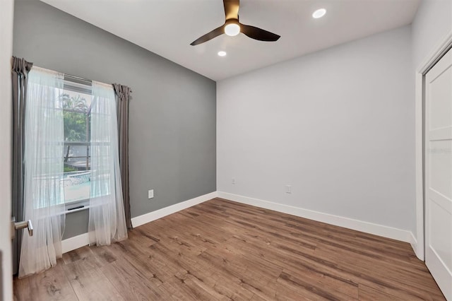 unfurnished room with ceiling fan and light wood-type flooring