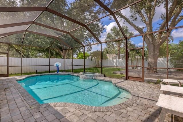 view of swimming pool with a patio, glass enclosure, and an in ground hot tub