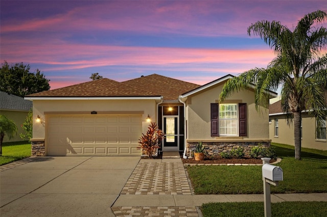 view of front of house with a lawn and a garage