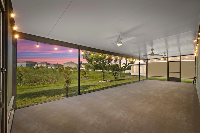 unfurnished sunroom with ceiling fan